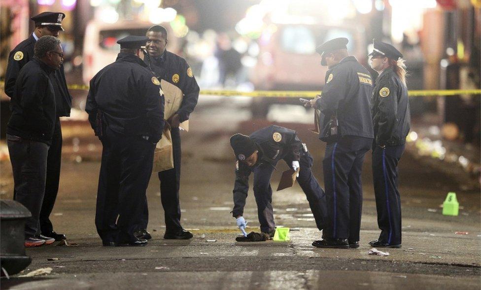 A crime scene technician collects clothing from the street as New Orleans Police investigate a fatal shooting at Iberville and Bourbon streets on Sunday, November 27, 2016, in New Orleans.