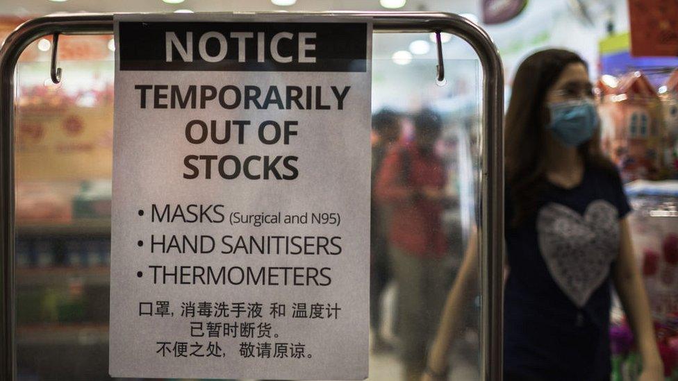 Pharmacy sign in Singapore saying masks out of stock