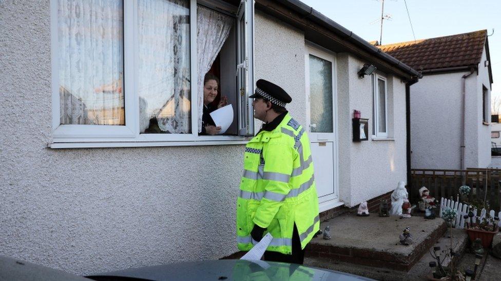 Police officer talks to resident