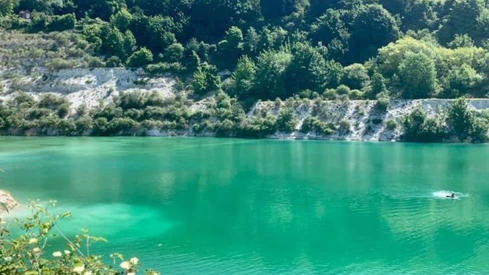 A person swimming in Old Kiln Lakes