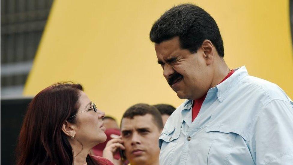 Venezuelan President Nicolas Maduro (right) gestures next to First Lady Cilia Flores during a rally in Caracas on 8 August, 2015