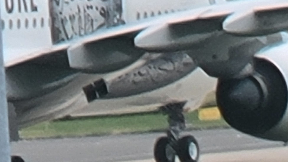 Close up of undercarriage of plane at airport