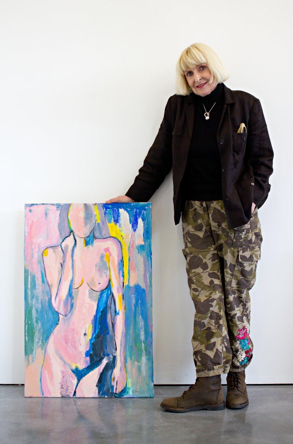 Geraldine Crimmins standing next to her artwork