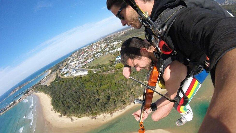 Glen Donnelly playing violin while skydiving