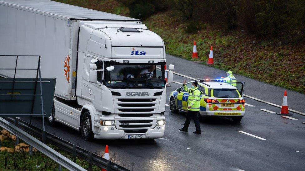 Lorry driver talking to a police officer in Dover