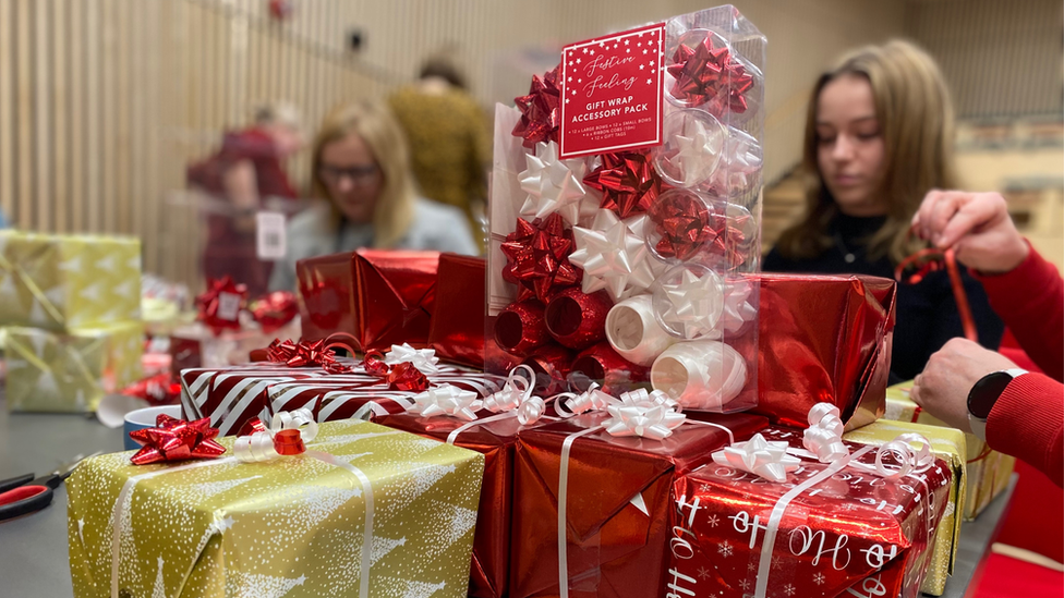 Volunteers wrapping presents for Christmas day