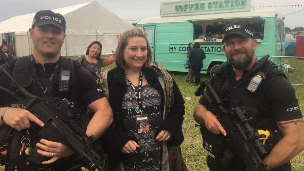 Woman with two armed officers at Download