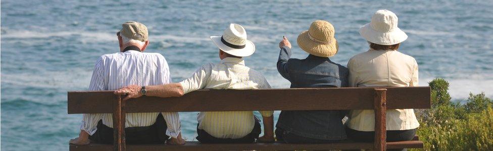 Elderly people sat on a bench