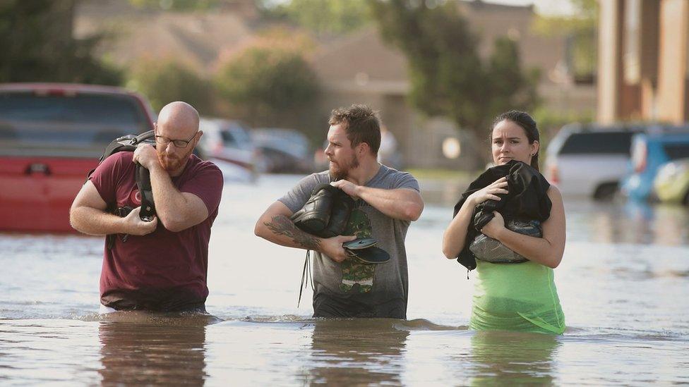 Houston residents try to keep dry after leaving their homes