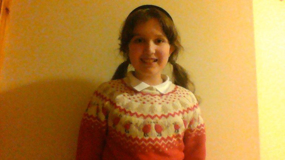 Girl in Christmas jumper.
