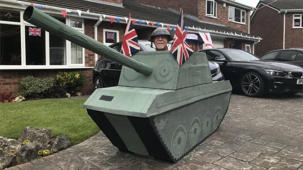 Residents of Portola Close in Grappenhall, Cheshire, celebrate VE Day in a model tank on 8 May 2020