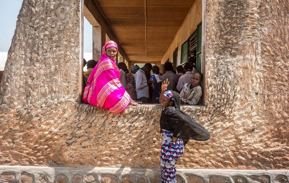 Voters queue at the polling station at the Koudoukou school in the flashpoint PK5 district in Bangui on December 14, 2015 where voting operations for the Constitutional Referendum are still underway