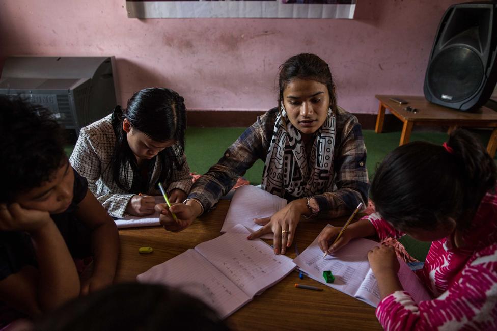 A teacher gives a lesson to girls in the Shakti Samuha safe house, in 2018