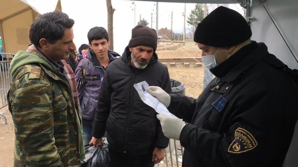 Macedonia policeman checking documents on border (February 2016)