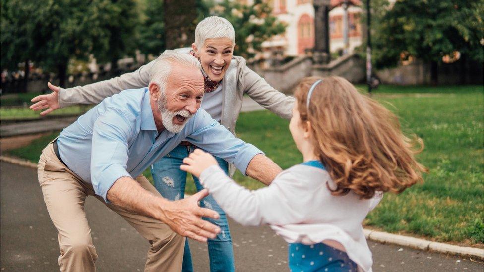 child running to grandparents