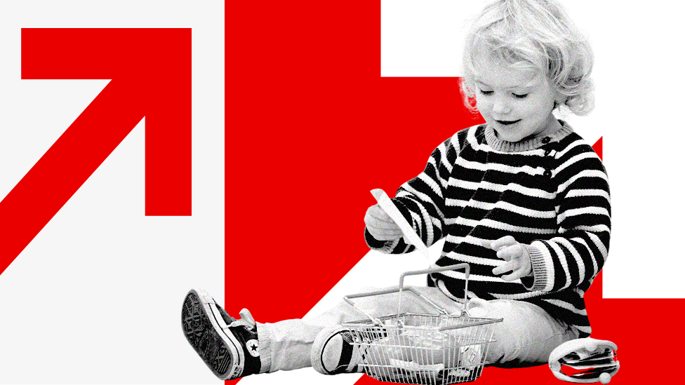 A toddler playing with toys against a background of red arrows