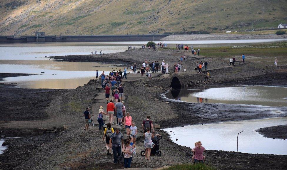 People walking along the old road at Spelga Reservoir