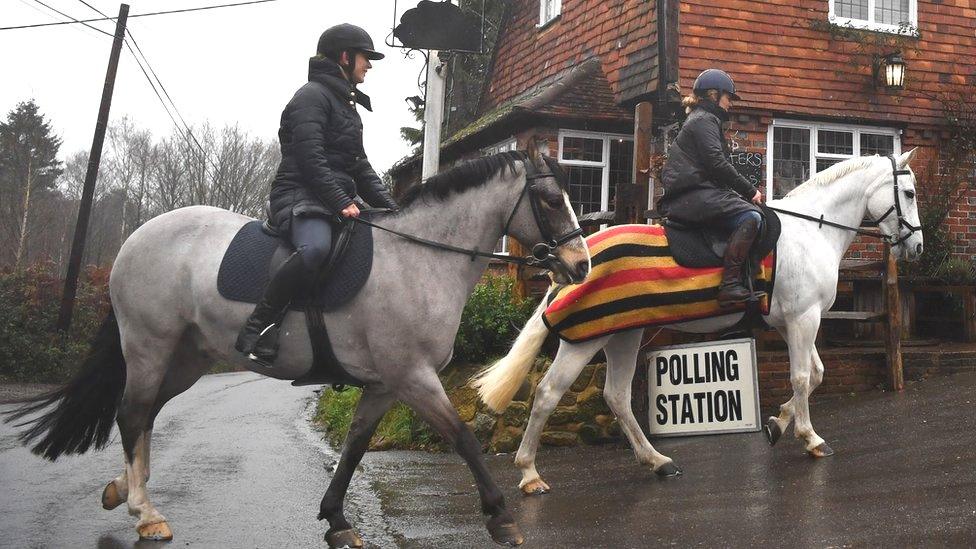 Horse riders arrive at a polling station in Chiddinstone Hoath