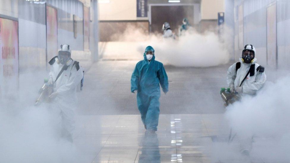 Volunteers disinfect a railway station in Hunan province, China, 4 February 2020