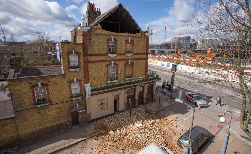 Rubble (bricks) strewn across the road outside The Duchess public house in Battersea