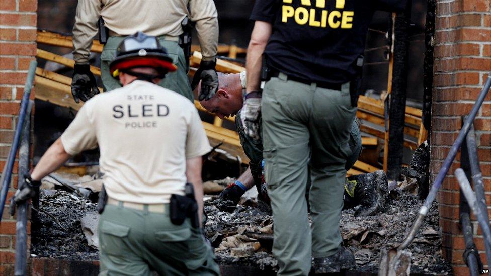 Investigators sift through ashes and charred debris inside the Mount Zion AME Church - 1 July 2015