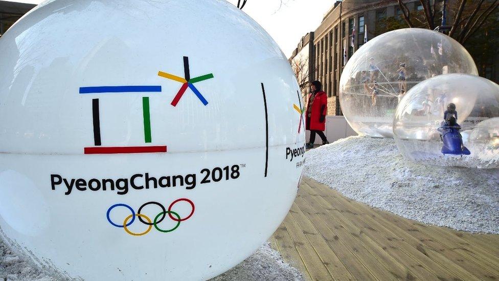 The emblem of the 2018 PyeongChang Winter Olympics, with a capital 'C', is seen on an advertisement ball outside the city hall in Seoul on January 26, 2016