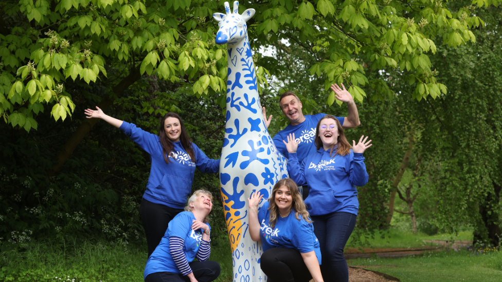 A group of Break supporters and one of the giraffes