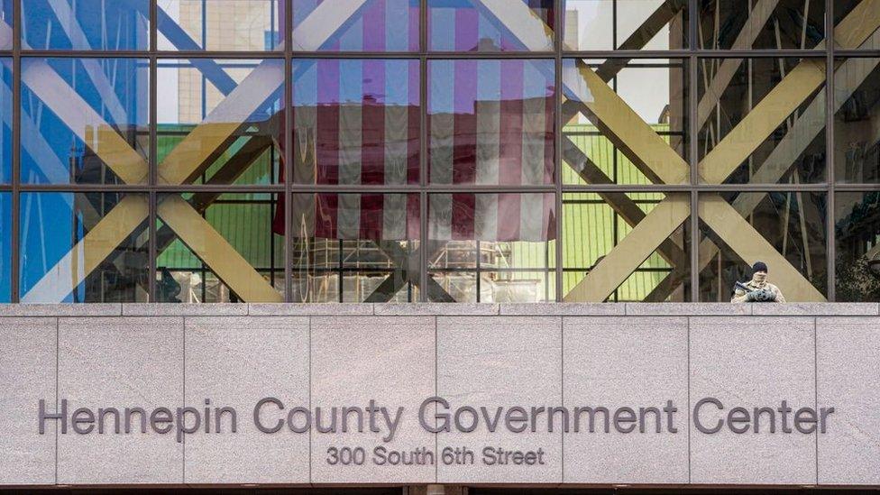 A member of the Minnesota National Guard stands guard outside the Hennepin County Government Center