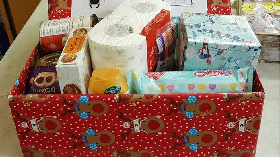 A decorated box full of household items and food