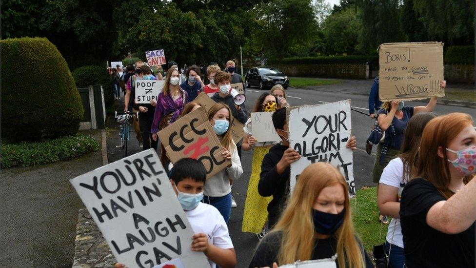 Protesters carrying signs make their way to Gavin Williamson's office