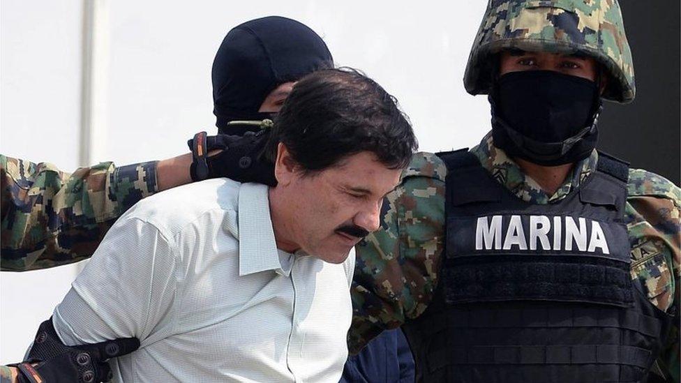 Mexican drug trafficker Joaquin Guzman Loera aka "el Chapo Guzman", is escorted by marines as he is presented to the press on 22 February 2014 in Mexico City