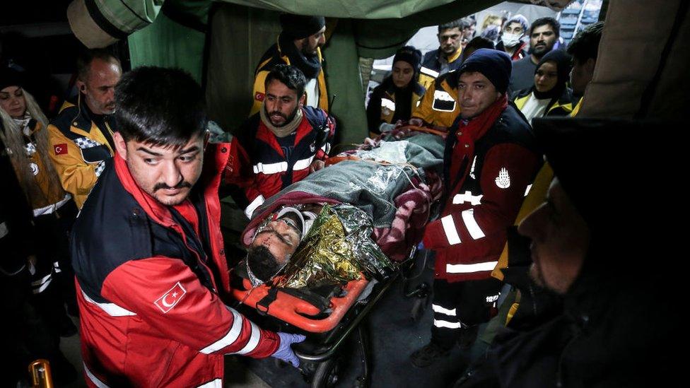 Survivor Hakan Yasinoglu being taken to ambulance