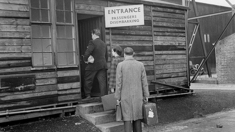 Passengers queue for customs at Luton Municipal Airport in 1951