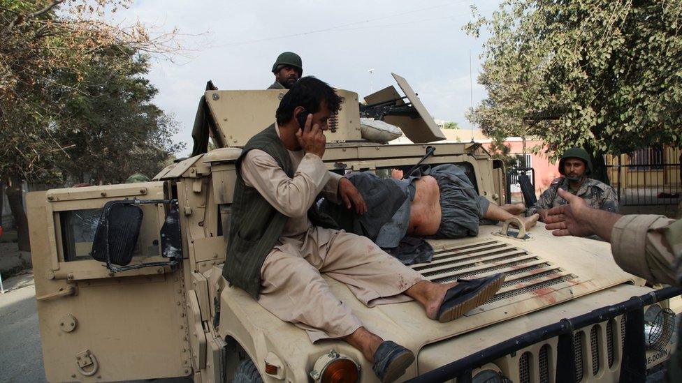 Members of Afghan security forces shift a civilian victim injured in fighting, to a local hospital in Kunduz, on 3 October 2015.