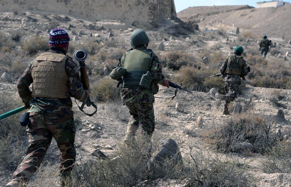 In this photograph taken on February 17, 2016, Afghan security forces patrol following an operation against Islamic State (IS) militants in Achin district in Nangarhar province.