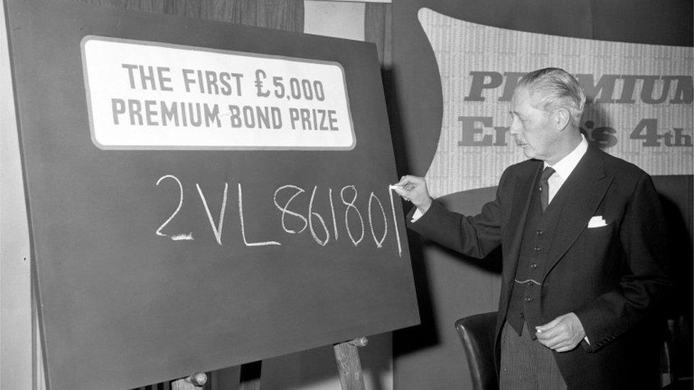 Harold Macmillan writing the number of a £5,000 Premium Bond draw