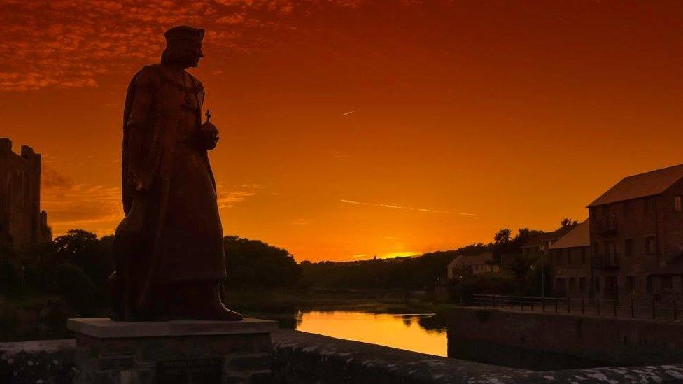 Henry VII statue overlooking Pembroke at sundown