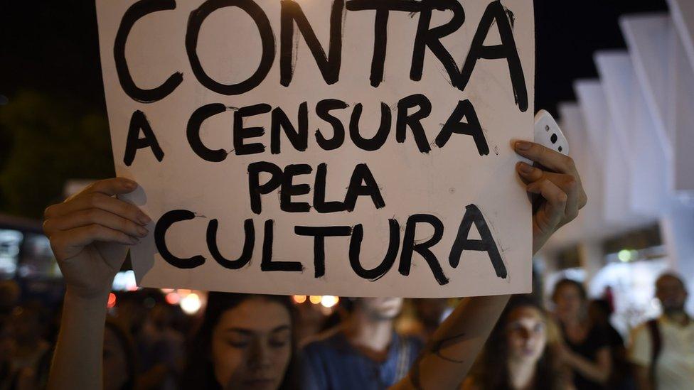 A demonstrator holds a sign 'Against censorship of culture' as artists and musicians gather at the Palacio das Artes during the 'Faca Voce Mesmo Sua Capela Sistina' (Make Your Own Sistine Chapel) exhibition by artist Pedro Moraleida, in Belo Horizonte, Brazil on October 9, 2017