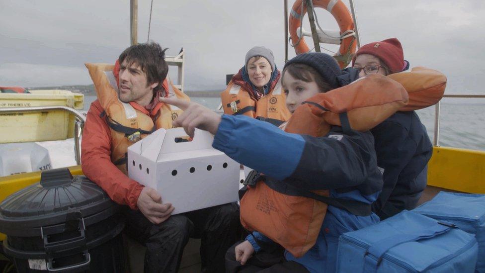 The family on a boat on the way to Bardsey Island