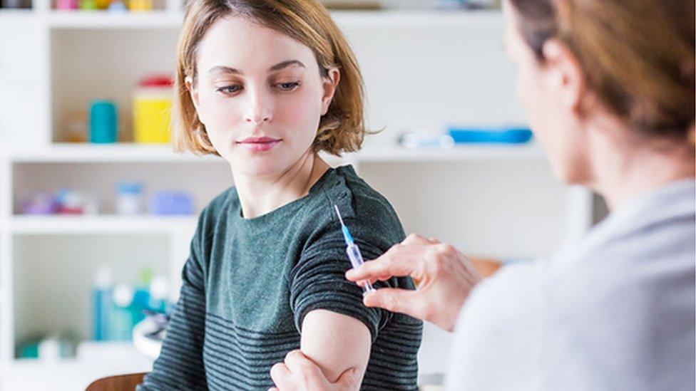 A young woman being vaccinated