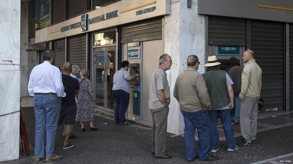 People line up at ATMs outside a National Bank branch in Athens, Greece, on 28 June 2015