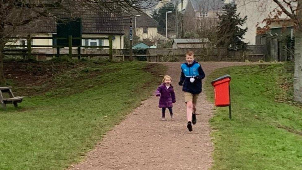 Jack crossing finishing line with sister