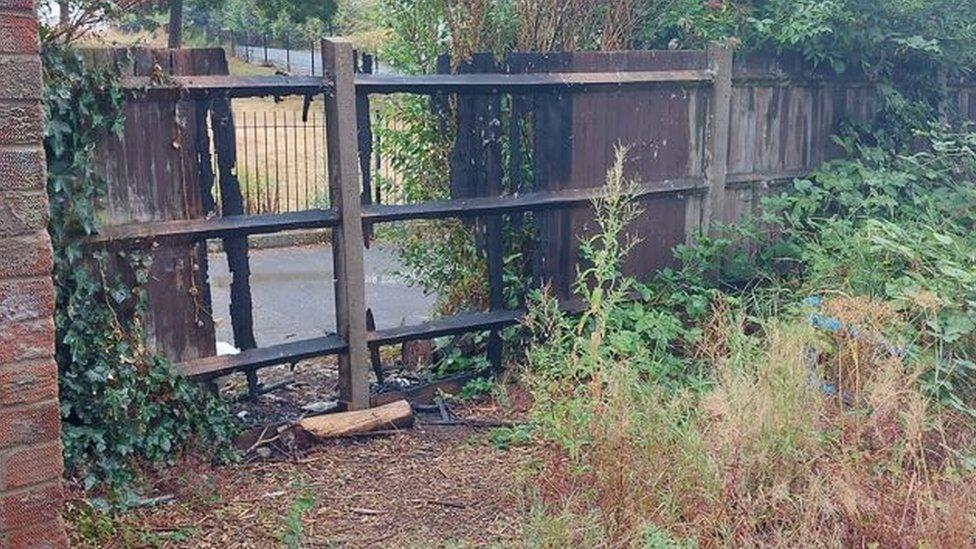 A picture of a damaged fence