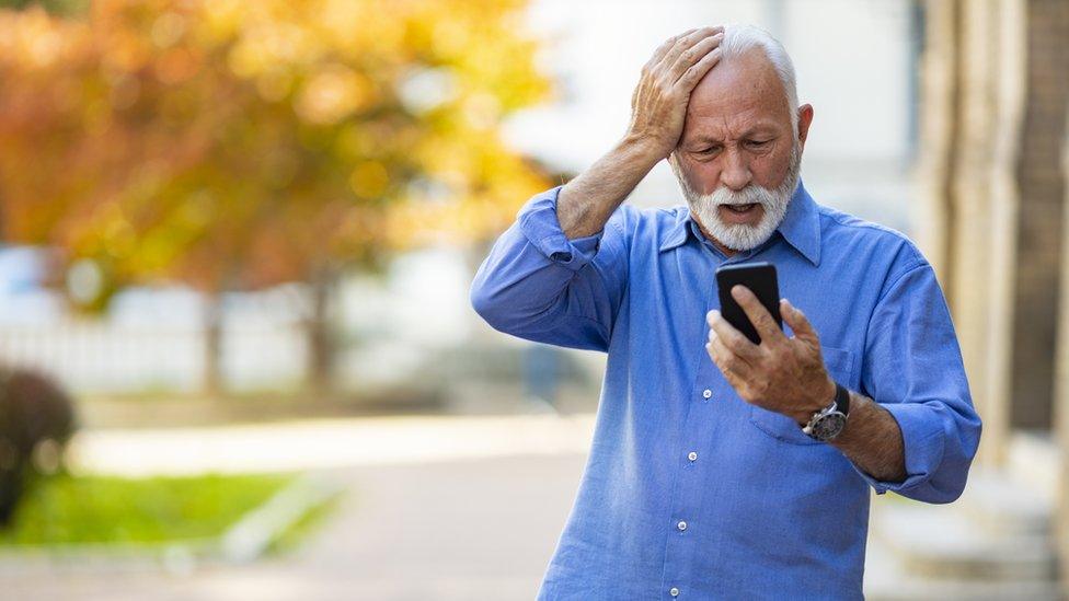 Old man surprised by phone