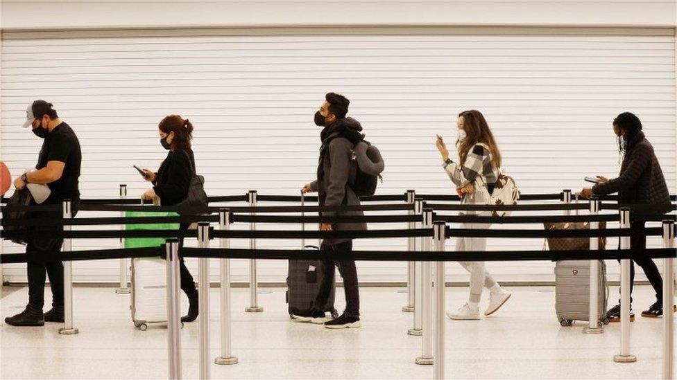 Passengers queue at arrivals in an airport