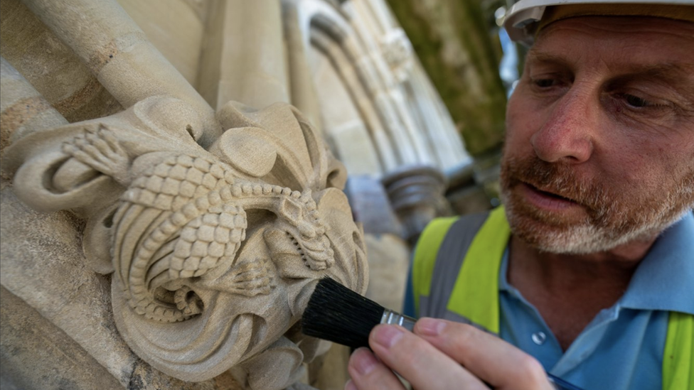 A clerk inspecting cathedral stone