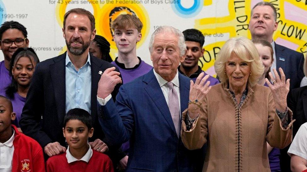 Britain's King Charles III, center, and Camilla, the Queen Consort, right, pose for a photograph with Gareth Southgate, England football manager and Prince's Trust ambassador, left, and children from St Peter's Primary School