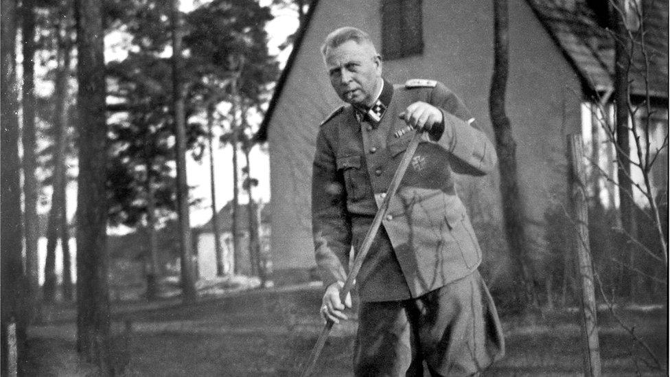 Man in Nazi uniform gardening