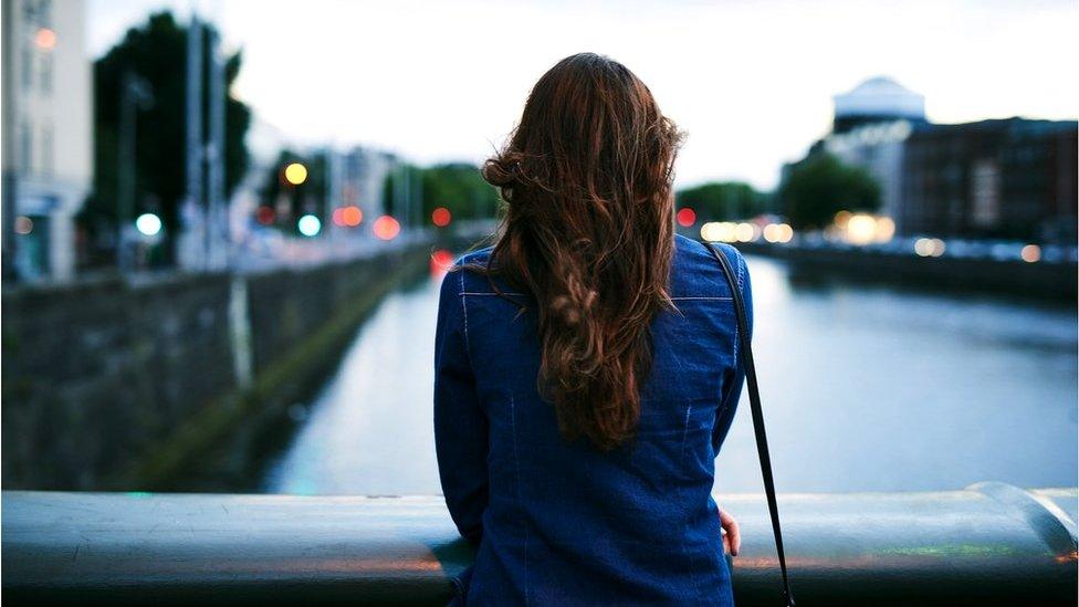 Woman looking from bridge