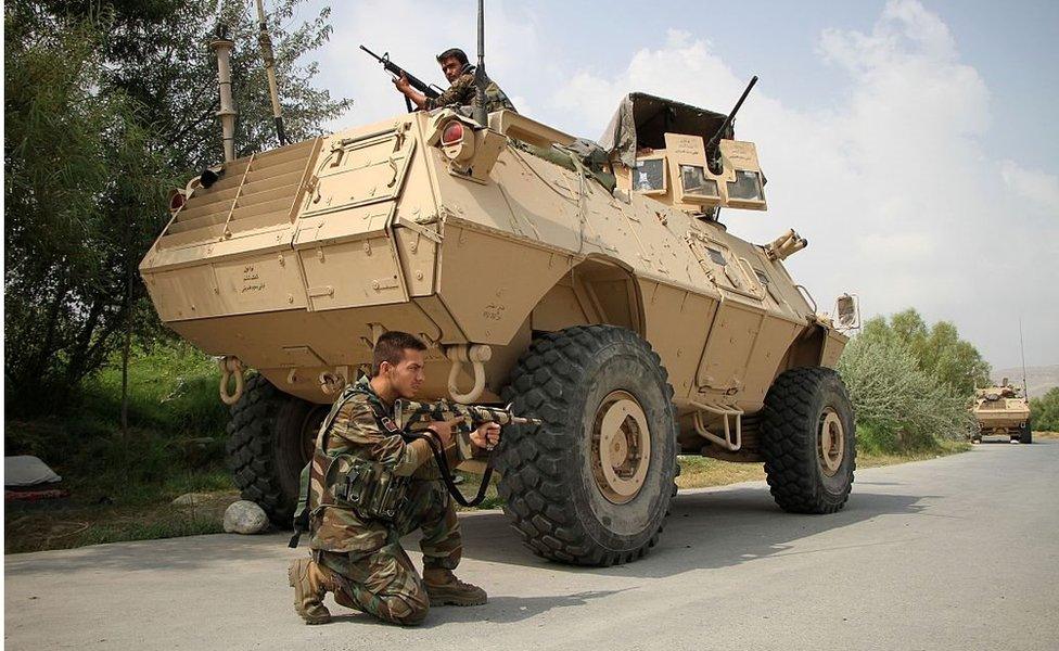 Afghan soldiers in and beside a vast armoured personnel carrier during an operation against an IS leader in Nangarhar, Afghanistan on 26 July 2016.